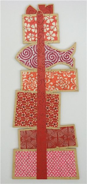 Stack of Gifts<br/>collage on wood<br/>13" x 5"<br/>2006 : Selected Jigsaw Puzzles : Amy Finley Scott